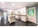 Open kitchen with white cabinets, stainless appliances, and a stained glass accented door at 1285 10Th Street Nw Blvd, Hickory, NC 28601