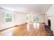 Bright living room with hardwood flooring, fireplace, and access to an outdoor patio at 1285 10Th Street Nw Blvd, Hickory, NC 28601