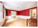 Spacious living room with hardwood floors, red accent wall, and natural light at 1285 10Th Street Nw Blvd, Hickory, NC 28601