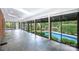 Indoor pool room with stone floors and multiple sliding doors to the backyard pool at 1285 10Th Street Nw Blvd, Hickory, NC 28601