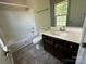 This bathroom features a tub/shower combo with a white vanity at 1300 Braveheart Ln, Charlotte, NC 28216