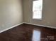 Simple bedroom with hardwood floor with lots of natural light from window at 1300 Braveheart Ln, Charlotte, NC 28216