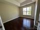 Neutral bedroom with ample natural light and rich hardwood flooring at 1300 Braveheart Ln, Charlotte, NC 28216