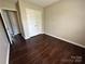 Hardwood bedroom offering a closet space with a door at 1300 Braveheart Ln, Charlotte, NC 28216