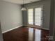Bright dining area with hardwood floors and double doors leading to the backyard at 1300 Braveheart Ln, Charlotte, NC 28216