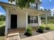 Home with vinyl siding, a covered front porch, and landscaped shrubbery along the front at 1300 Braveheart Ln, Charlotte, NC 28216