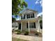 Two-story home with vinyl siding, black shutters, a front porch, and manicured landscaping at 1300 Braveheart Ln, Charlotte, NC 28216