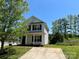 Two-story house with vinyl siding, a front porch, and a concrete driveway at 1300 Braveheart Ln, Charlotte, NC 28216