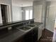 A kitchen area features dark cabinets, laminate countertops, and an open view of the dining area at 1300 Braveheart Ln, Charlotte, NC 28216