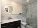 Modern bathroom featuring a stylish vanity, round mirror, and glass-enclosed shower with marble tiling at 1320 Fillmore Ave # 426, Charlotte, NC 28203