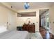 Bright bedroom with dark wood floors, a dresser, and a door to a balcony at 1320 Fillmore Ave # 426, Charlotte, NC 28203