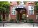 Inviting brick building entrance with awning and manicured landscaping offering a warm welcome at 1320 Fillmore Ave # 426, Charlotte, NC 28203