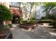 Inviting courtyard with manicured landscaping, brick archway, and pathways throughout the community at 1320 Fillmore Ave # 426, Charlotte, NC 28203