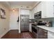 Well-equipped kitchen featuring stainless steel appliances, ample white cabinetry, and stylish backsplash at 1320 Fillmore Ave # 426, Charlotte, NC 28203