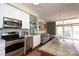Cozy living space seamlessly connecting to the kitchen and balcony with hardwood floors at 1320 Fillmore Ave # 426, Charlotte, NC 28203