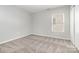Bedroom featuring neutral carpet, light-filled window and neutral paint at 13816 Riding Hill Ave, Charlotte, NC 28213