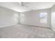Spacious bedroom with neutral carpet, three bright windows and modern ceiling fan at 13816 Riding Hill Ave, Charlotte, NC 28213