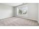 Bedroom featuring neutral carpet, natural light and neutral paint at 13816 Riding Hill Ave, Charlotte, NC 28213