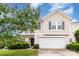 Two-story home featuring a two-car garage, traditional architecture, and lush landscaping at 13816 Riding Hill Ave, Charlotte, NC 28213