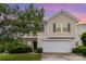Two-story home featuring a two-car garage, traditional architecture, and lush landscaping at 13816 Riding Hill Ave, Charlotte, NC 28213