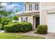 Inviting home with well-manicured bushes, a black front door, and a cozy entrance at 13816 Riding Hill Ave, Charlotte, NC 28213