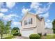 Exterior side view featuring a two-car garage and manicured lawn at 13816 Riding Hill Ave, Charlotte, NC 28213