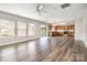Open-concept living space with wood flooring, adjoining kitchen, and slider access to the backyard at 13816 Riding Hill Ave, Charlotte, NC 28213