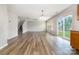 Open-concept living space with wood flooring, slider access to the backyard, and staircase at 13816 Riding Hill Ave, Charlotte, NC 28213