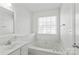 Relaxing bathroom with a soaking tub beneath a window, featuring a single sink vanity at 1707 Kashmir White Ln, Fort Mill, SC 29708