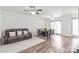 Open dining area featuring a ceiling fan, dark wood table, and a comfortable leather couch at 1707 Kashmir White Ln, Fort Mill, SC 29708