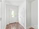 Bright foyer with wood floors and a white entry door leading to the exterior at 1707 Kashmir White Ln, Fort Mill, SC 29708