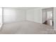 Spacious living room with neutral carpeting and ample natural light from the doorway at 1707 Kashmir White Ln, Fort Mill, SC 29708