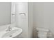 Close-up of powder room with white fixtures and silver hardware at 1707 Kashmir White Ln, Fort Mill, SC 29708