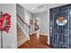 Inviting foyer with hardwood floors, a staircase, and a view into the bedroom at 17913 Ragtop Day Ln, Cornelius, NC 28031