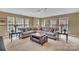 Spacious living room with a large sectional sofa, coffee table, and an abundance of natural light at 17913 Ragtop Day Ln, Cornelius, NC 28031