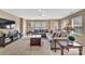Open-concept living room featuring a cozy sectional sofa, modern furnishings, and ample natural light at 17913 Ragtop Day Ln, Cornelius, NC 28031