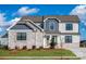 Beautiful two-story home featuring a stone facade, gray siding, and professionally landscaped front yard at 1852 Yardley St, Rock Hill, SC 29732