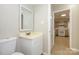Cozy half bathroom featuring a single sink vanity and a door that opens to the neighboring kitchen space at 1905 Mereview Ct # 21, Charlotte, NC 28210