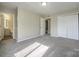 Bedroom features neutral carpet, a closet, and an ensuite bathroom at 1905 Mereview Ct # 21, Charlotte, NC 28210