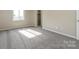 Well-lit bedroom boasts neutral carpet, natural light, and closet at 1905 Mereview Ct # 21, Charlotte, NC 28210