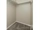 Walk-in closet features shelving and neutral carpeting at 1905 Mereview Ct # 21, Charlotte, NC 28210