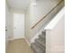 Bright entryway with tile flooring, a staircase featuring white banisters and carpeted steps, and a convenient coat closet at 1905 Mereview Ct # 21, Charlotte, NC 28210
