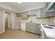 A bright kitchen featuring neutral cabinets, white appliances, and a view into the half-bath, creating a welcoming atmosphere at 1905 Mereview Ct # 21, Charlotte, NC 28210