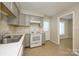 Well-lit kitchen featuring gray cabinets, a white range, and tiled flooring at 1905 Mereview Ct # 21, Charlotte, NC 28210