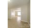 Open living area with tiled floors and ample natural light from a large window at 1905 Mereview Ct # 21, Charlotte, NC 28210