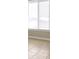 Well-lit living room featuring a large window with blinds and tile flooring, creating a bright and inviting atmosphere at 1905 Mereview Ct # 21, Charlotte, NC 28210