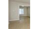 The neutrally decorated living room features an open transition to a neighboring room, enhanced by attractive tile flooring at 1905 Mereview Ct # 21, Charlotte, NC 28210