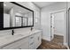 Modern bathroom featuring double vanity with marble countertop, a large mirror, and walk-in shower at 1933 Hendricks St, Rock Hill, SC 29732