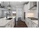 A bright, spacious kitchen features an island with a sink, stainless steel appliances and white cabinetry at 1933 Hendricks St, Rock Hill, SC 29732
