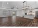 Spacious living room and kitchen area with modern light fixtures and hardwood floors at 1933 Hendricks St, Rock Hill, SC 29732
